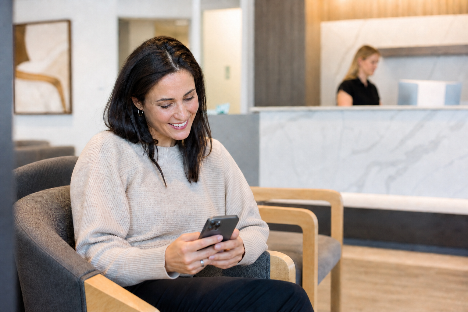 Patient Smiling in Bright Dental Waiting Room with Phone